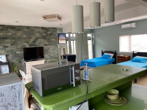 a living room with a television on a table at MountView studio in city in Port Louis