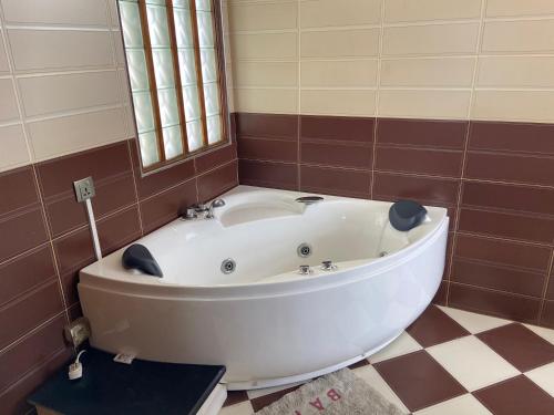 a large white bath tub in a bathroom at MountView studio in city in Port Louis