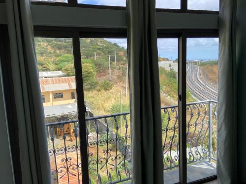 a window with a view of a train tracks at MountView studio in city in Port Louis