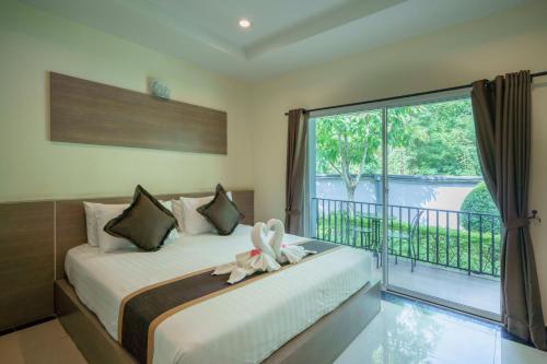 a bedroom with a bed with a stuffed animal on it at Ioon Resort ไออุ่นรีสอร์ท in Sara Buri