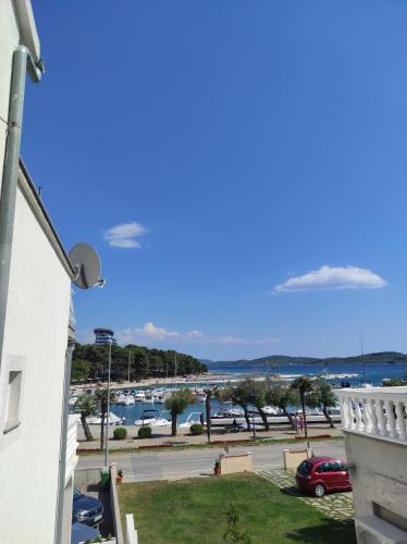 a view of a marina from the balcony of a building at Apartment and Rooms Dalmatiko in Vodice