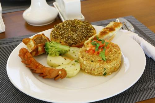 a white plate of food with bread and vegetables at Weekend Hotel Sari in Jeddah