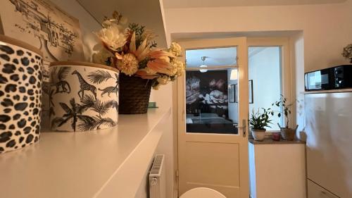 a kitchen with a counter with a vase of flowers on it at Designerwohnung Afrika sehr zentral gelegen in Hannover
