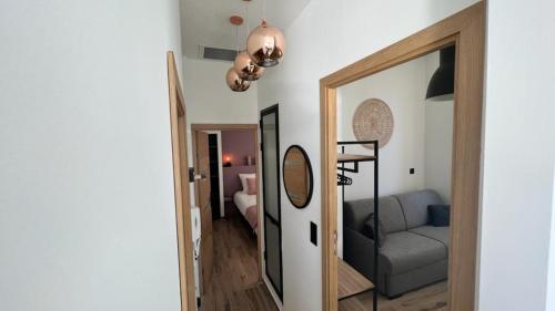 a hallway with a mirror and a couch in a room at Face au Vieux Port Vue 180 de Notre Dame au Panier in Marseille