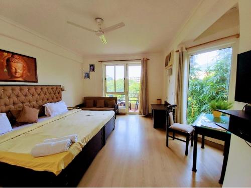 a bedroom with a large bed and a large window at Aloha Serenity Apartments in Rishīkesh