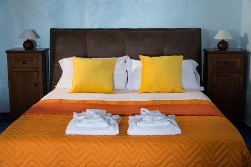 two pairs of shoes sitting on a bed with yellow pillows at Villa Paradise (Amalfi Coast - Luxury Home - Beach) in Vietri sul Mare