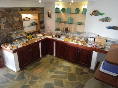 a kitchen with a counter with food on it at Nefeli Hotel Leros in Agia Marina