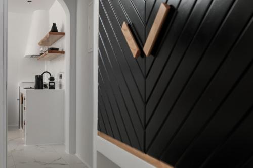 a hallway with a wooden letter on the wall at Naxos White Concept in Naxos Chora