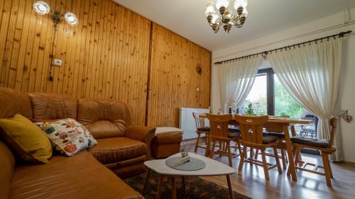 a living room with a couch and a table at Zimski san in Ravna Gora