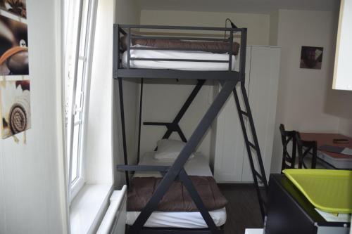 a bunk bed in a room next to a window at Appart-alma in Saint-Laurent-sur-Sèvre