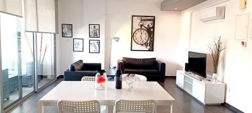 uma sala de estar com uma mesa branca e cadeiras em Dezo Luxury town Apartment em Lárnaca