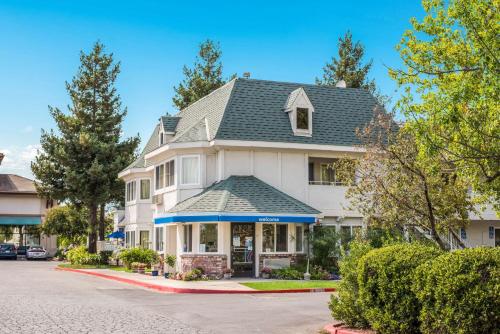 a white house with a gray roof at Motel 6-Rohnert Park, CA in Rohnert Park