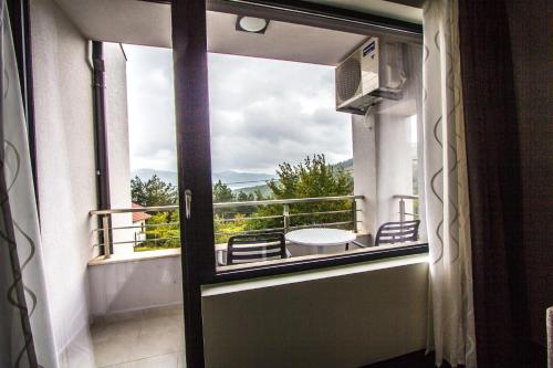 a door to a balcony with a view at Family Hotel Friends Villa in Enchets