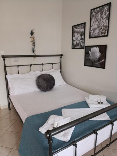 a bedroom with a bed with a metal headboard at Maria's Apartment Nafplio in Nafplio