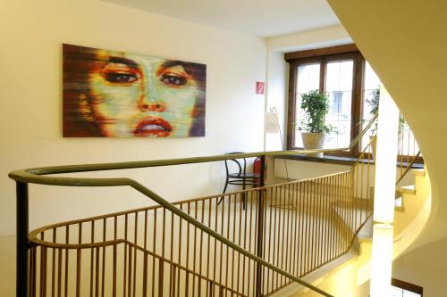 a staircase in a building with a painting on the wall at Hotel Steinerwirt1493 in Zell am See