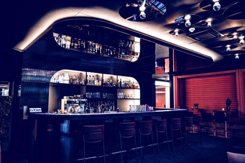 a bar in a restaurant with bar stools at The Flamingo in Timmendorfer Strand