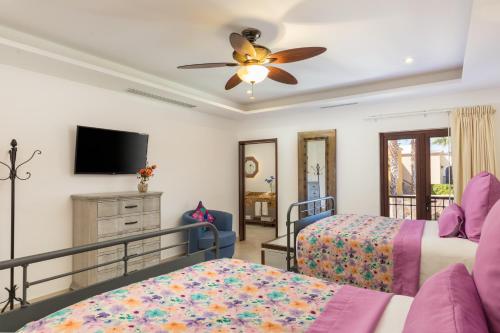 a bedroom with two beds and a ceiling fan at The Residences at Hacienda Encantada in Cabo San Lucas
