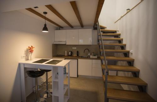 a kitchen with a spiral staircase in a room at Apartman Mama Marija in Dubrovnik
