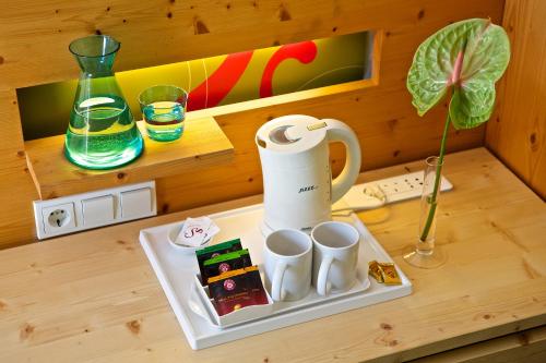 a toy kitchen with a tea kettle and cups on a table at Hotel Steinerwirt1493 in Zell am See