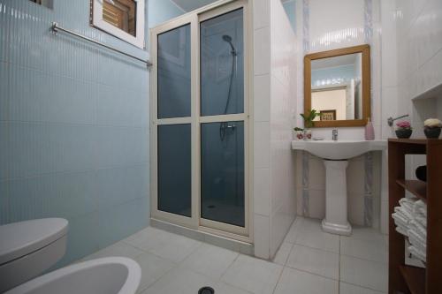 a bathroom with a shower and a toilet and a sink at The Bay Apartments in Sarandë