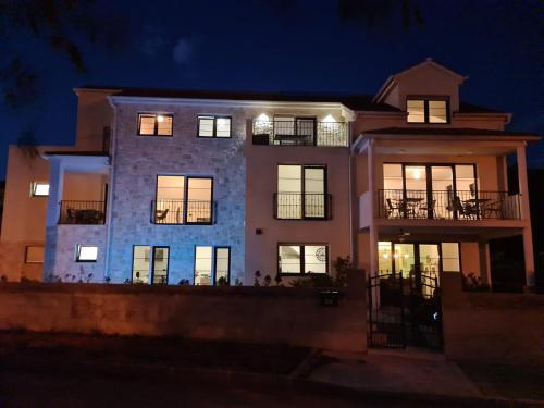 a large house at night with its lights on at Appartments Akrapovic in Vrsi