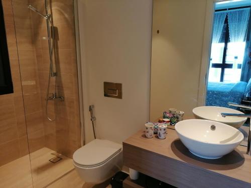 a bathroom with a sink and a toilet and a shower at Blue Diamond Ayla - Restricted to Family stays in Aqaba