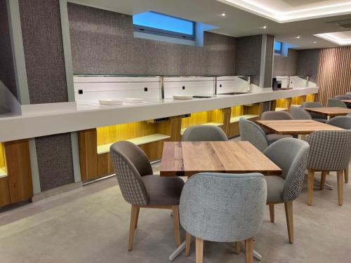 a restaurant with tables and chairs and a counter at Hotel Noy in Almuñécar