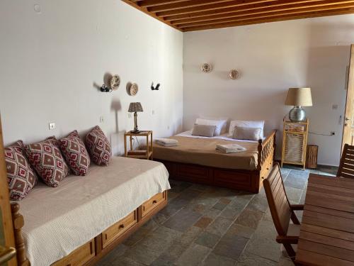 a bedroom with two beds and a couch at Teresa's Home in Líndos