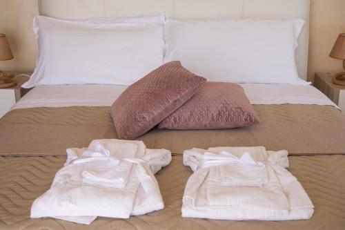 two towels are sitting on top of a bed at Villa Paradise (Amalfi Coast - Luxury Home - Beach) in Vietri sul Mare