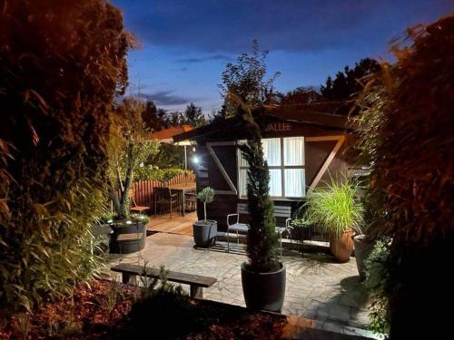 a house with potted plants in front of it at La Vallée in Seneffe