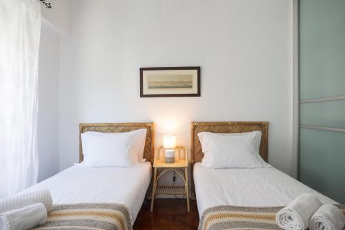 two beds sitting next to each other in a room at Charming TM Flat by the Ocean with a View in Cruz Quebrada