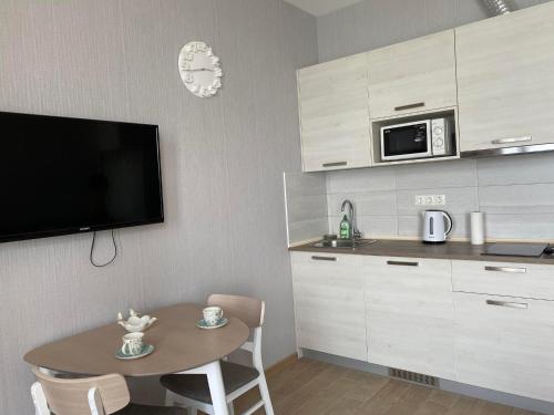 a small kitchen with a table and a microwave at Gonio Seaside Residence in Gonio