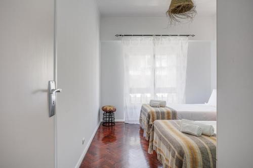 a bedroom with two beds and a window at Charming TM Flat by the Ocean with a View in Cruz Quebrada