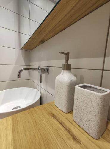 a bathroom with a sink and a soap dispenser on a counter at Antelope Studio 1 in Thessaloniki
