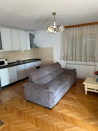 a living room with a couch and a kitchen at Zajim Apartment in Umag