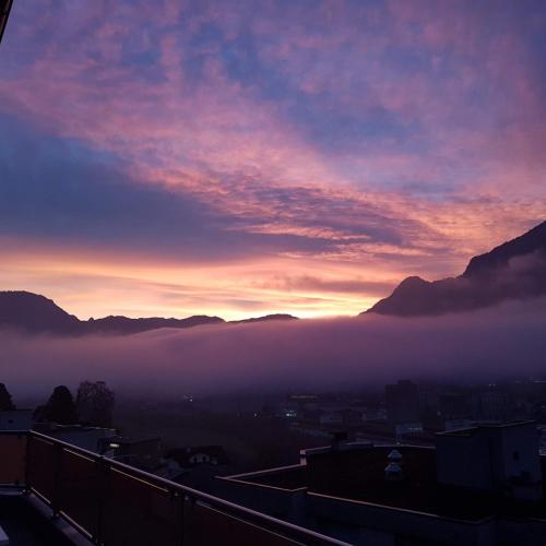 a view of a foggy city at sunset at Ferienwohnung Bally in Brunnen