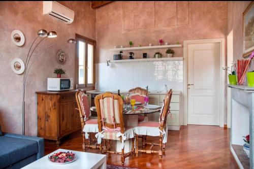 a kitchen with a table and chairs in a room at Cozy CENTRAL apartment in Florence - spectacular views of Duomo in Florence