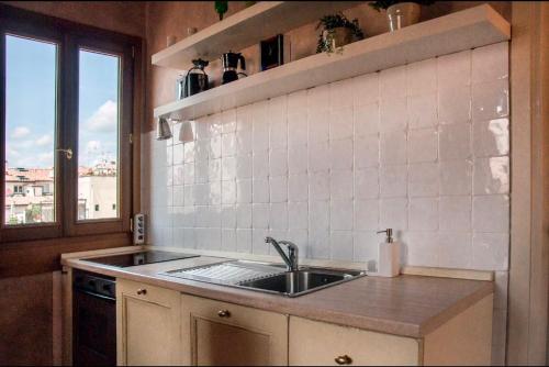 a kitchen with a sink and a window at Cozy CENTRAL apartment in Florence - spectacular views of Duomo in Florence