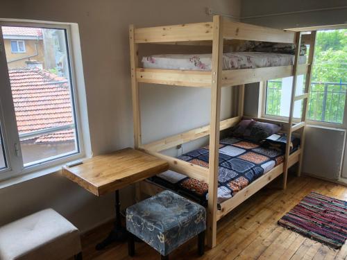 a room with two bunk beds and a desk at Hakuna Matata Guest House in Plovdiv