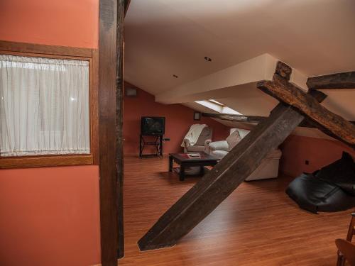 a room with a loft with a living room at Auténtica buhardilla en el centro de Béjar in Béjar
