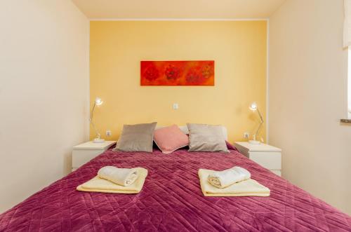 a bedroom with a large bed with two towels on it at Apartments Hortensia in Pula