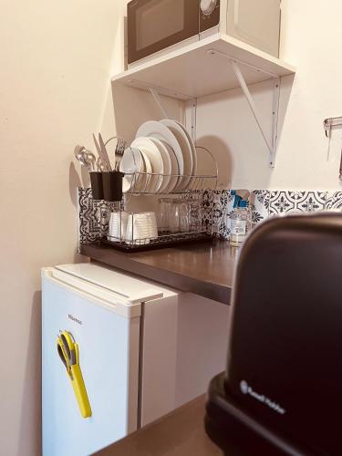 a kitchen with a counter with a small refrigerator at Bella Lux Holiday Condos in Durban