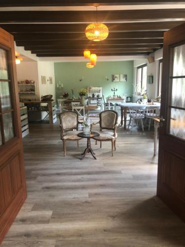 a living room with chairs and a table at Bed&Breakfast Eifelpension Brückenschenke in Fuchshofen