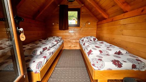 a small room with two beds in a cabin at Tara Place - Camp Rabrenovic in Mojkovac