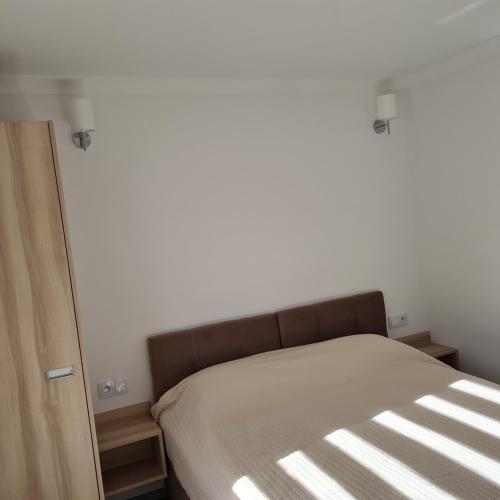 Ένα ή περισσότερα κρεβάτια σε δωμάτιο στο Apartamenty Zełwągi 15