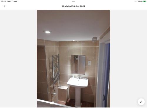 a bathroom with a sink and a mirror at Bosloe in Helston