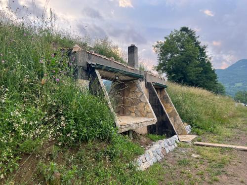 an old stone bridge on a hill with grass at Tara Place - Camp Rabrenovic in Mojkovac