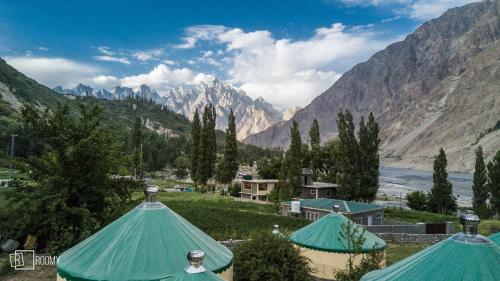 a view of a valley with mountains and tents at Roomy Yurts, Gulmit Hunza in Gulmit