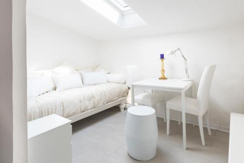 een witte woonkamer met een bank en een tafel bij SOGNO NEL RINASCIMENTO in Florence