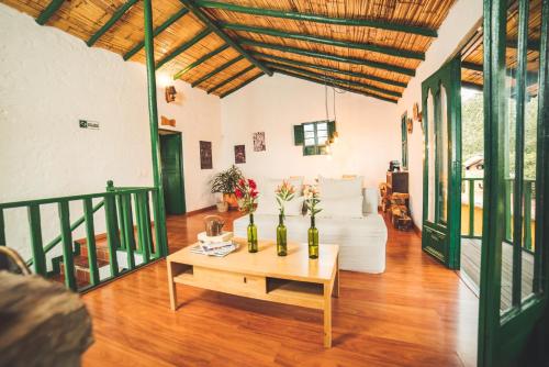a living room with a white couch and a table at Estancia San Antonio in Guasca